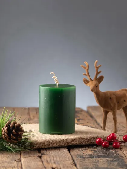 A deep green pillar candle, another versatile classic for the holiday season.
