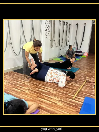 Assisting a student in a prone twist helps to gently open the hips and lower back after a strong practice.