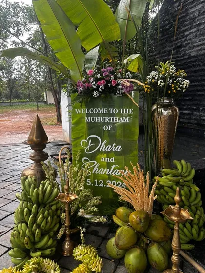 A welcome sign for a Muhurtham that immediately sets a traditional and lush tone, using banana leaves, coconuts, and brass lamps as key design elements.