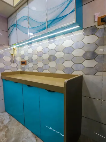 The finished look with under-cabinet lighting that highlights the unique texture of the backsplash tiles.
