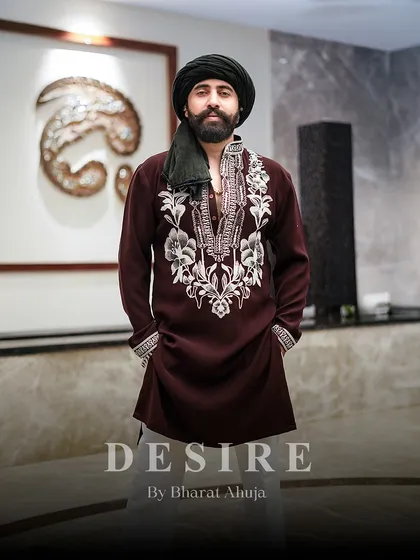 A look of quiet authority. My custom maroon kurta, with its intricate white embroidery, offers a sophisticated alternative to traditional festive colors, ensuring you stand out with elegance.