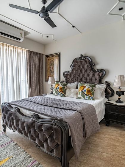 The 'Eternity' bedroom featuring a grand, tufted velvet bed frame in a classic style. The room combines traditional furniture with modern comforts and styling.