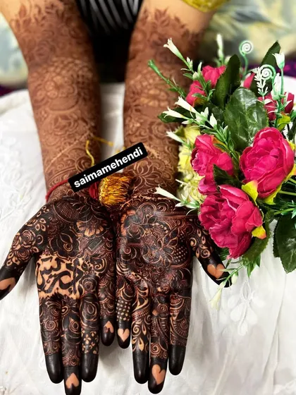 Another look at a beautifully matured henna stain, showcasing the depth of color and the intricacy of the design. The dark fingertips and detailed patterns are perfect for any celebration.