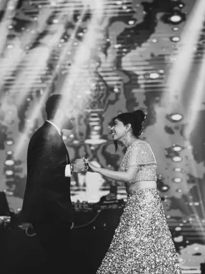 A classic black and white photo of a couple's dance, capturing a timeless and elegant moment.