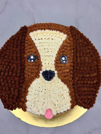 Cutie alert! This adorable dog face cake was so much fun to make. The fur is created with hundreds of tiny piped stars of chocolate and vanilla buttercream.