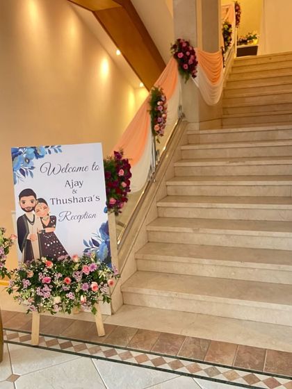 We also decorate auxiliary spaces to match the main theme. Here, we've decorated the venue's staircase with drapes and floral bunches and placed a personalized welcome sign for the couple's reception.