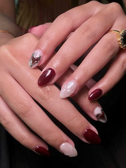 This angle highlights the contrast between the deep red and the soft, sheer base, making the chrome accents pop.