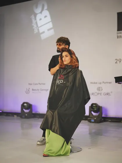 A behind the scenes moment from the Wella live hair show. This shows the makeup application in progress, creating a beautiful base that will complement the final hair styling on stage.