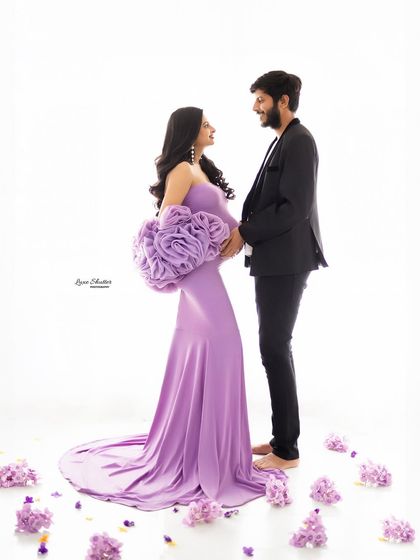 A joyful and romantic shot of the couple surrounded by flower petals. Their shared gaze and happy expressions tell a beautiful story of love.