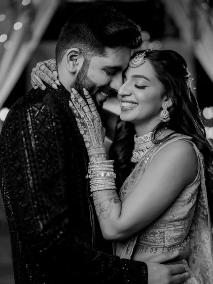 In the quiet moments between the grand celebrations, true feelings shine the brightest. This black and white portrait from Zaee and Kartik's Sangeet is all about their genuine connection and happiness.