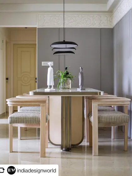 The elegant dining area of the 'YBJ Residence', featured in India Design World. The marble-topped table and modern chairs create a sophisticated space for entertaining.