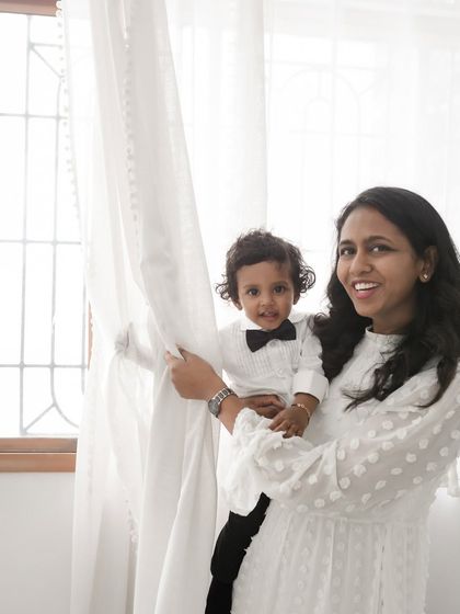 A sweet mother-son portrait by the window, using natural light to create a soft and gentle mood.