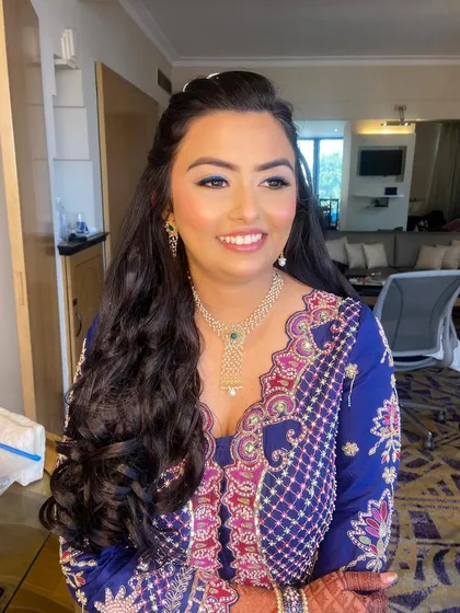 The silk-like skin finish and a pop of blue liner for Bansi’s mehendi look. A fun way to add color to your pre-wedding events.