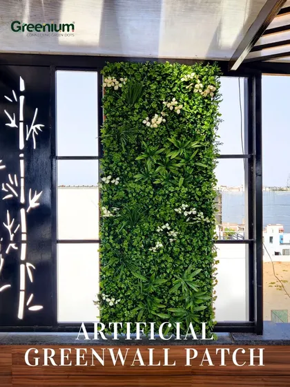 A close-up of an artificial green wall patch installed on a terrace. This is a great way to add a splash of green to a specific area, like under a pergola, without committing to a full wall.