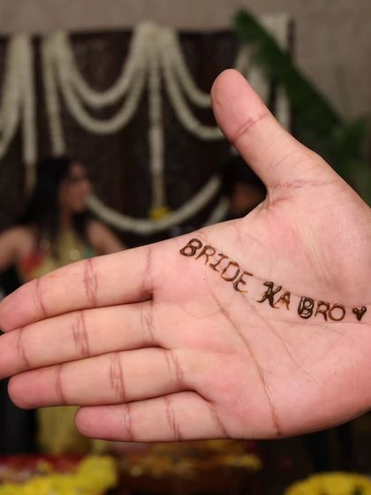 It's all about the personal touches. This "Bride ka Bro" henna design is a fun, quirky detail that adds personality and shows the playful spirit of the family.