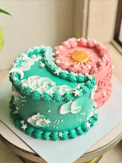 It's giving cosmic energy. This unique design features two half-cakes joined together, one representing the moon and the other the sun, each with its own flavor and color scheme.