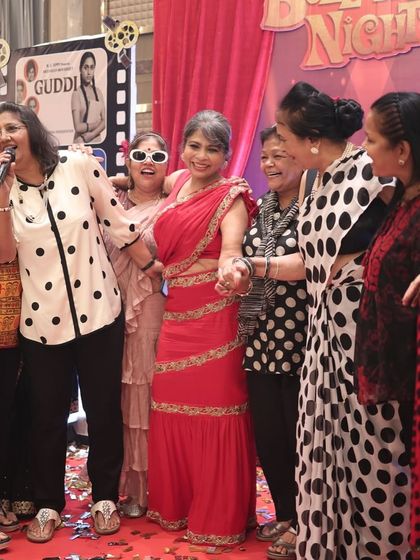 Moments like these are priceless. Guests took to the stage for an impromptu sing-along, fully embracing the retro Bollywood theme. I facilitate an environment where spontaneous fun can happen.