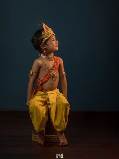 Looking up with a divine expression, this little Krishna captures the spirit of the festival.
