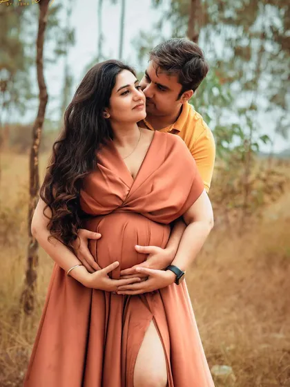 A loving embrace during an outdoor maternity session. I focus on poses that feel natural and highlight the couple's connection.