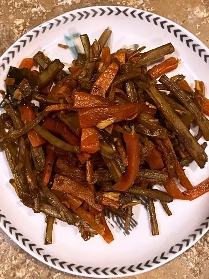 This Smoked Kharsinga and Carrot stir-fry is our salute to indigenous wild foods. We stir-fry smoked Kharshinga (a wild vegetable) with carrots and Malabar tamarind, celebrating tribal culture and sustainable foraging.