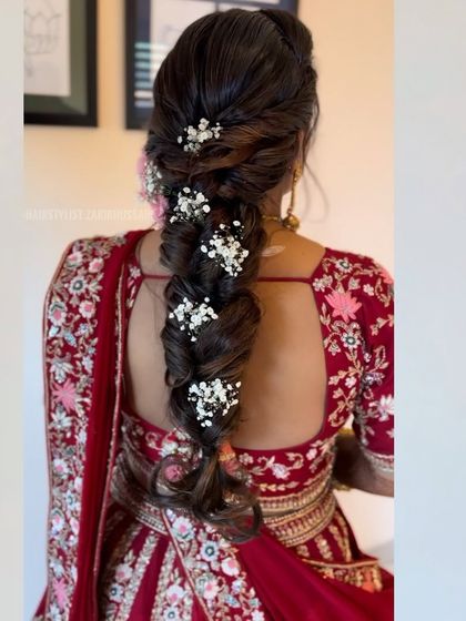 A beautiful, thick fishtail braid decorated with sprigs of baby's breath. This is a romantic and popular choice for pre-wedding events like an engagement or Mehendi.
