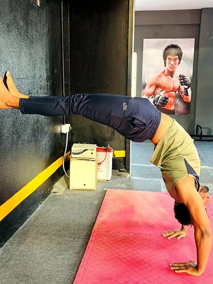 An adult student works on his wall-assisted backbend, a great drill for building spinal flexibility.