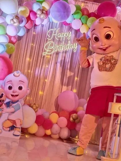 This is a perfect example of how our Cocomelon JJ mascot completes a first birthday party theme. The mascot fits right in with the decorations, creating a magical experience and perfect photo opportunities for your little one.