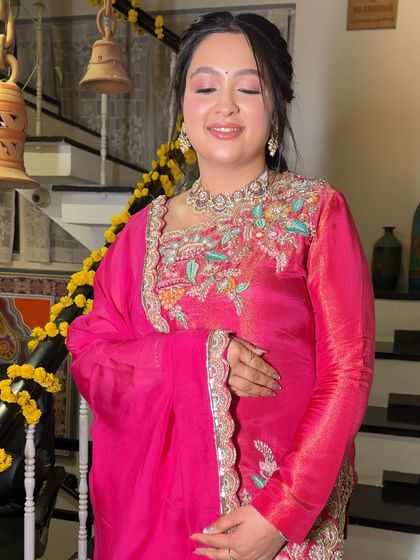 A close-up of the soft eye makeup for this festive look. The shimmering pink shadow and flawless skin create a look that is both devotional and beautiful.