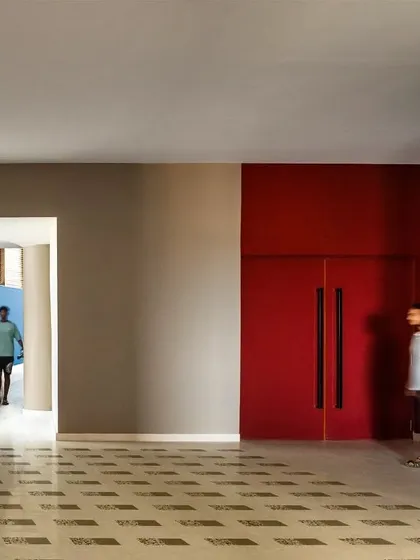 We use color to define spatial thresholds and guide circulation, as seen here in the MARC Auditorium. The contrast between neutral tones and bold primary colors creates a memorable architectural journey.