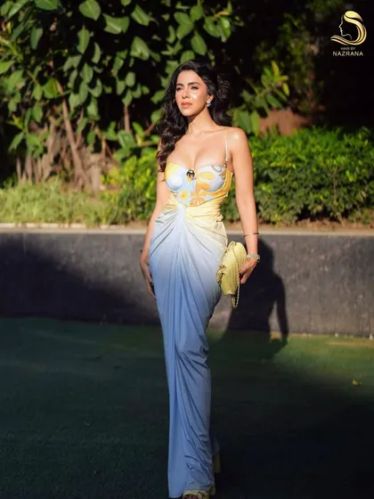 The full look, with voluminous waves that create a glamorous and confident silhouette.