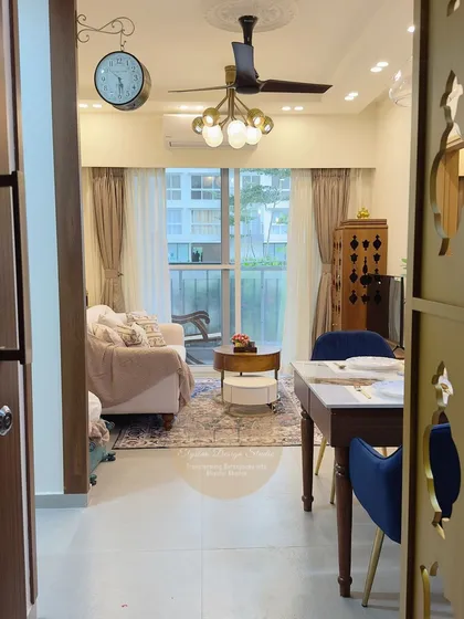 A view from the entrance into a cozy living and dining area. The space is designed for senior living, with comfortable seating, clear pathways, and warm, inviting decor.