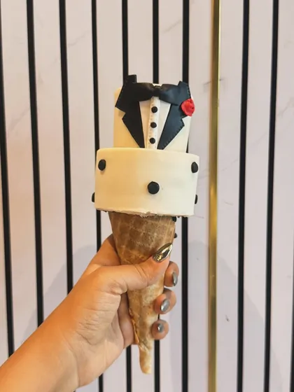 The tuxedo cakesicle, complete with a tiny bow tie, buttons, and a rose. It’s a small piece of edible art, perfect for celebrating a special occasion in style.