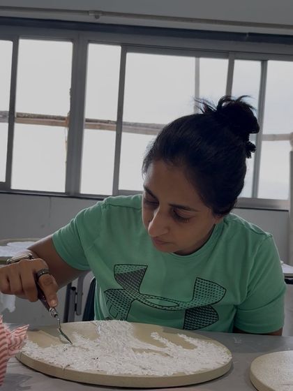 Spreading the texture paste with a palette knife, another step in the meditative process of creation.