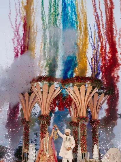 A destination wedding in Goa calls for a spectacular moment. I designed this Varmala ceremony with a grand, lotus-inspired mandap and a stunning display of rainbow-colored smoke, creating a magnificent celebration against the coastal sky.