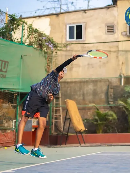The peak of the serve, as the player leaps to connect with the ball. I teach the biomechanics of a powerful and effective serve.