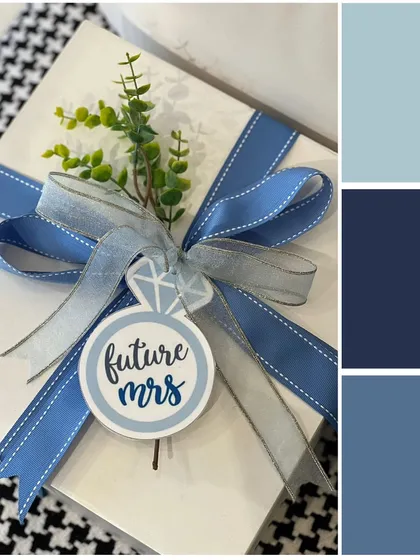 A beautifully wrapped gift box for a "Future Mrs". The blue ribbon and custom tag with a diamond ring detail make it a perfect gift for a bridal shower or engagement party.