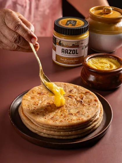 A product in its perfect setting. For Aazol's D2C ghee, we showed it being generously added to a hot paratha, an image that instantly communicates taste, tradition, and the simple pleasure of home-cooked food.