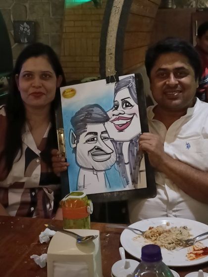 A couple with their portrait, a memento from their meal at Mountain High.