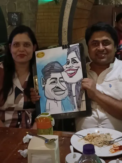 A couple with their portrait, a memento from their meal at Mountain High.