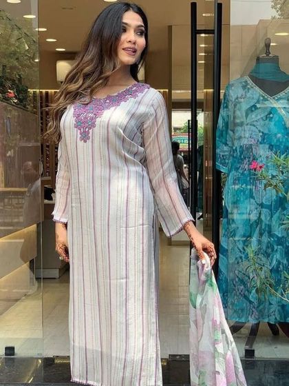 An off-white kurta with a lovely printed dupatta. The heavy thread embroidery on the neckline adds a touch of festive glam.