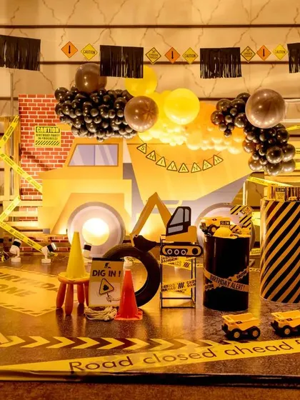 For the little builder in your life, I design action-packed construction zones. This setup features a full-scale backdrop with a dump truck, caution tape, traffic cones, and custom signage, turning the party space into a fun and interactive work site.