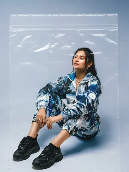 This shot from the 'Shanaya-Verse' series uses a plastic bag prop to create a unique, high-fashion look, all while demonstrating the iPhone's camera capabilities.