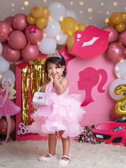 Posing like a true star. Her adorable expression and pose perfectly capture the fun and fantasy of our Barbie-themed photoshoots.