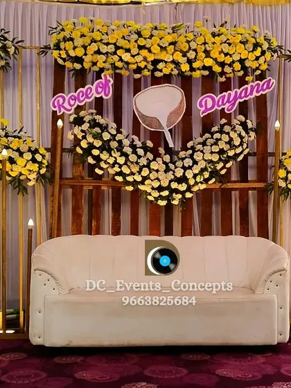 A simple yet elegant Roce stage with yellow florals and candle-like lighting. The wooden backdrop and coconut motif are perfect for a traditional and intimate ceremony.