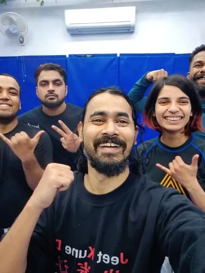 The instructor with a group of students after a session on Jeet Kune Do concepts, focusing on adaptability and real-world application.