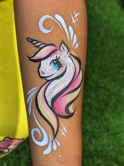 A beautiful unicorn temporary tattoo with a pink and yellow mane and sparkling white accents.