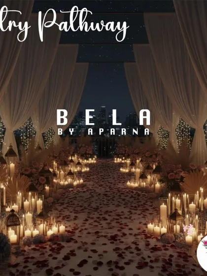I design dramatic entryways that build anticipation for the big moment. This pathway is lined with a sea of candles in glass holders and scattered rose petals, leading to the main event space.