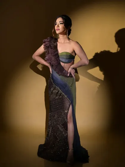 A full-length shot of Ridhima Pandit in this unique, high-slit gown. The color gradient and texture make it a standout piece for any special occasion.