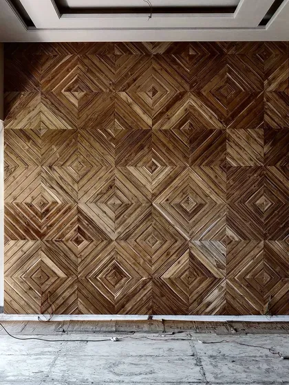A work-in-progress shot of an intricate wooden feature wall for a drawing area. This geometric pattern, crafted from reclaimed wood, is designed to bring immense warmth and detailed texture to the space.