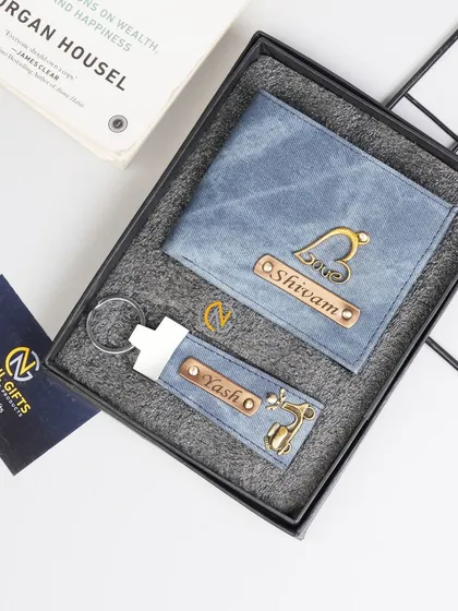 A personalized wallet and keychain set in blue denim, featuring a 'Love' charm on the wallet and a deer charm on the keychain.